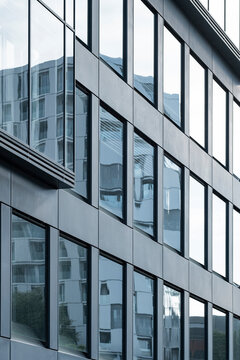 Geometric glass architecture with facade reflection, structure detail and pattern design emphasizing modern light contrast and metallic clarity within a minimalist urban environment