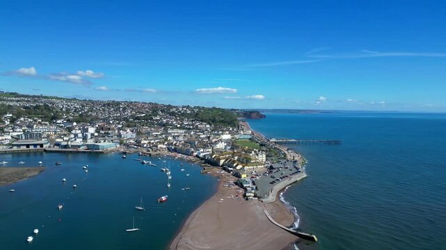 Teignmouth, South Devon, England: DRONE VIEWS: The drone circles Teignmouth and the River Teign estuary showing the Pier in the distance. Teignmouth is a popular UK holiday destination and port town.
