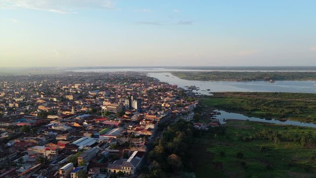 Panoramic aerial view of Iquitos city, bustling metropolis on the Amazon River in Peru's jungle, during a warm sunset