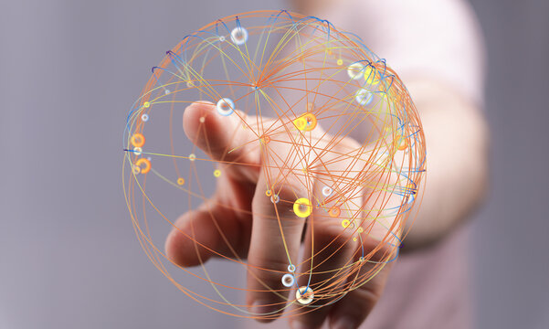 Abstract image of a hand interacting with a digital sphere representing global connection and networking. Great for technology, busin