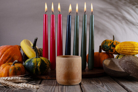 Kwanzaa, african holiday Kwanzaa with decoration of seven candles in red, black and green colors, vegetable harvest, corn. Greeting card banner. Happy Kwanzaa
