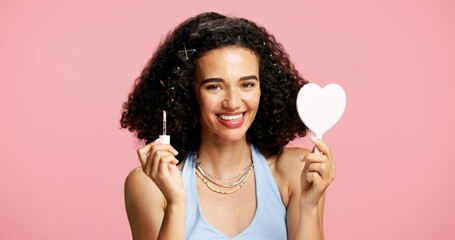 Cosmetics, mirror and woman portrait with lip gloss in studio, color product or happiness for...