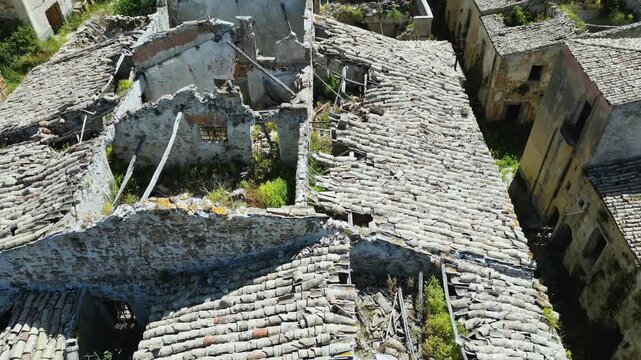 Aerial drone footage of old Poggioreale, Sicily: abandoned ghost town destroyed by the 1968 earthquake, surrounded by hills and silence. Ideal for history, decay, and documentary projects.