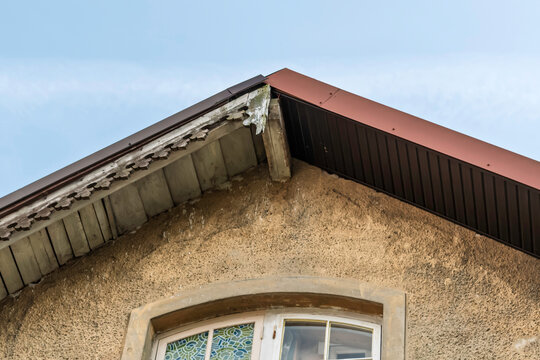 Renovation replaces old roof slope with modern metal panels and highlights loss of historic detail and cultural heritage.