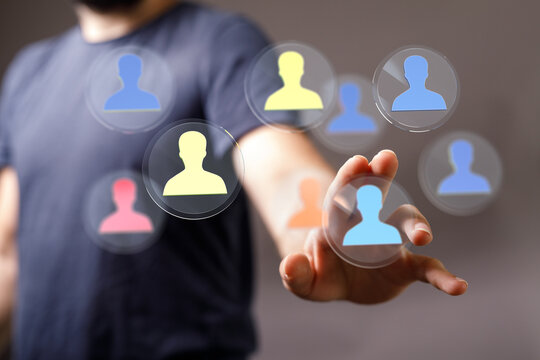 Concept of teamwork selection and hiring process. Hand pointing towards digital avatar icons symbolizing people and collaboration. Suitable for - Powered by Adobe