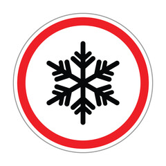 Circular warning sign with a black snowflake icon inside a red border on a white background. Symbol represents icy or cold conditions, frost warning, winter hazard, and safety alert.