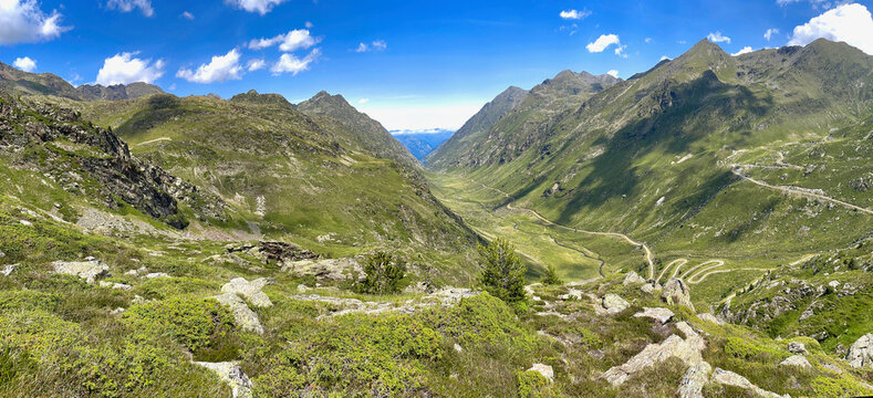 A mountain range with a clear blue sky and a body of water in the distance