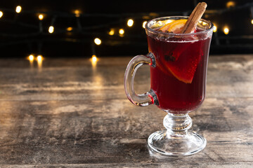 Mulled Wine with Orange and Cinnamon Sticks and Christmas decoration. Copy space