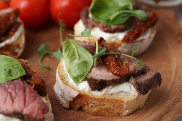 Bruschettas with roast beef served on table, closeup