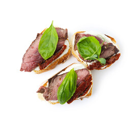Bruschettas with roast beef, cream cheese, basil and sun-dried tomato isolated on white, top view