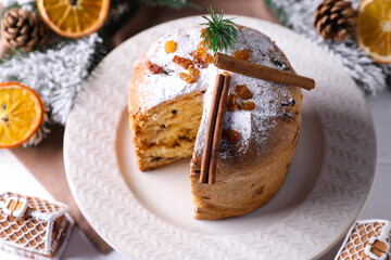 Christmas food. Delicious Panettone cake and festive decor on white table, above view