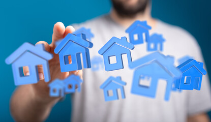 A hand reaching towards floating blue house icons, representing real estate, property ownership, and investment ideas. Perfect for illustrating