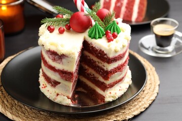 Tasty cake with Christmas decor on black table, closeup