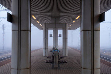 Budapest, Hungary - December 19, 2024: Empty railway platform stretches into dense fog, with...