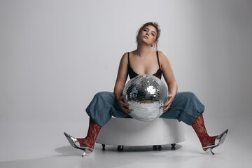 Young Woman Hugging Disco Ball on White Background