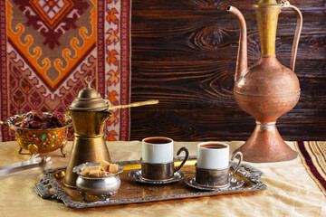 cup of coffee and vintage coffeepot on wooden table