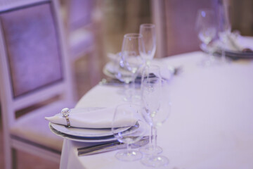 Elegant dining setup in a softly lit banquet hall for an upscale event during the evening