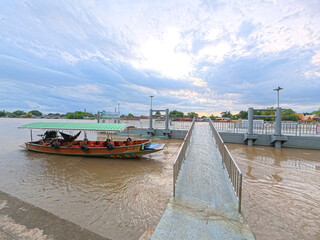 Tourist boats at a pier on the Chao Phraya River in Phra Nakhon Si Ayutthaya, Thailand