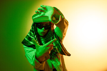 Confident young woman posing with hip hop vibe