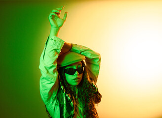 Woman posing in green and yellow lights with urban style