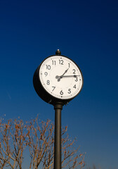 Vintage outdoor clock against clear blue sky