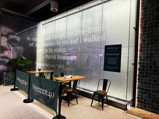 Obraz premium Cafe seating at nineteen40 in Dublin, Ireland with frosted glass wall art and branding