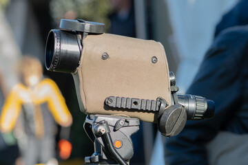 The optical device is mounted on a tripod and pointed forward for observation