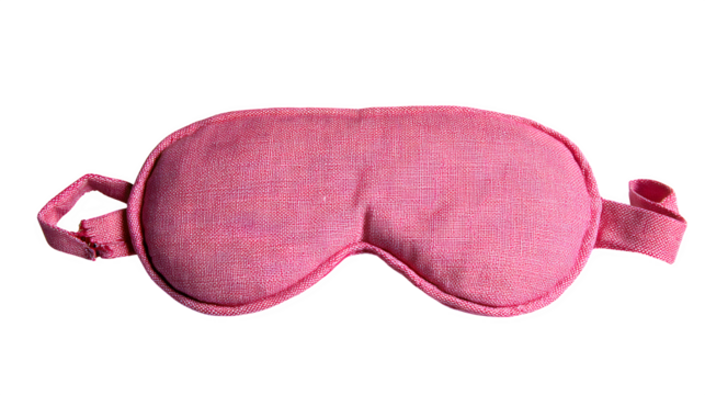 pink sleeping eye mask with elastic straps, soft travel accessory, isolated on white background