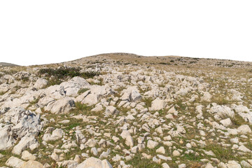 Rocky terrain with sparse vegetation on rolling hills. Isolated object