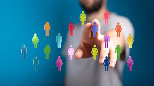 Abstract image of a hand touching colorful people icons, symbolizing technology, global communication, and networking with a blue background. Id
