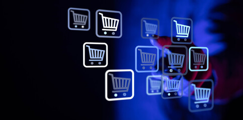 Digital shopping concept showing online sales, e-commerce, and modern technology. Human hand interacting with digital shopping cart icons.