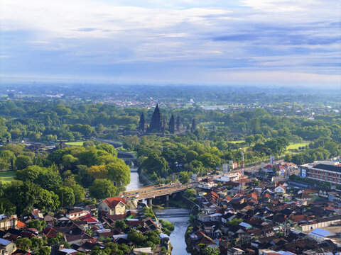 Aerial view of the Prambanan Temple complex, a testament to ancient artistry, rises majestically amidst a sea of lush greenery, Yogyakarta, Daerah Istimewa Yogyakarta, Indonesia.