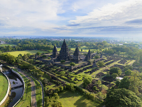 Aerial view of ancient Prambanan Temple rises majestically amidst lush greenery under a vast sky, Yogyakarta, Daerah Istimewa Yogyakarta, Indonesia.