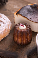 Various types of desserts and pastries on an old wooden background
