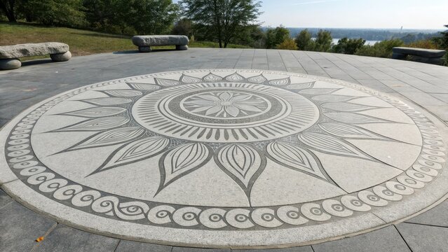 Sun inspired circular henna pattern on stone paving outdoors