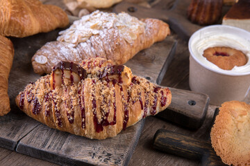 Various types of desserts and pastries on an old wooden background