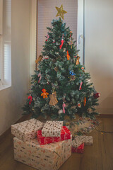 Home New Year's interior. Christmas tree decorating with  handmade toys and gifts