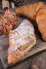 Various types of desserts and pastries on an old wooden background
