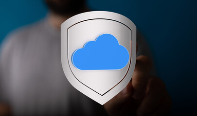 Secure cloud computing concept with hand protecting a cloud icon, symbolizing data protection, backup, and online safety. Focus on di