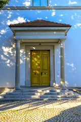 Ornate wooden temple door of the Protestant Church in Uster, featuring carved details and stone arch under natural daylight