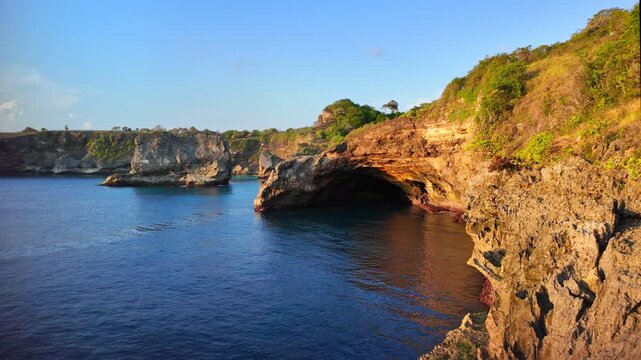 Picturesque cliffs rise steeply from ocean depths, embodying the wild beauty of Indonesia coastal regions, attracting visitors seeking extraordinary views