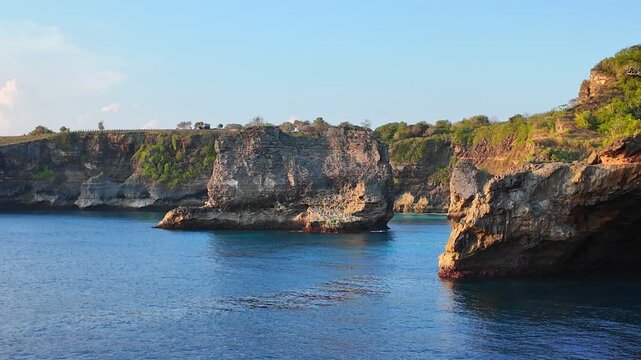 Rugged coastal cliffs meeting vast ocean create mesmerizing scenery in Indonesia, inviting travelers and adventurers to explore landscapes full of wonder