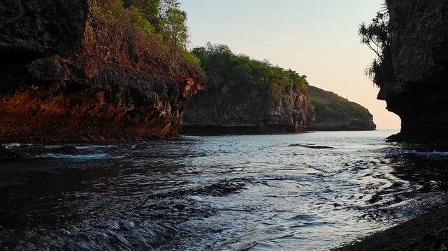 Ocean tide surges in rocky cave, creating dramatic views in Indonesia, showcasing power of nature and inviting tranquil exploration, slow motion