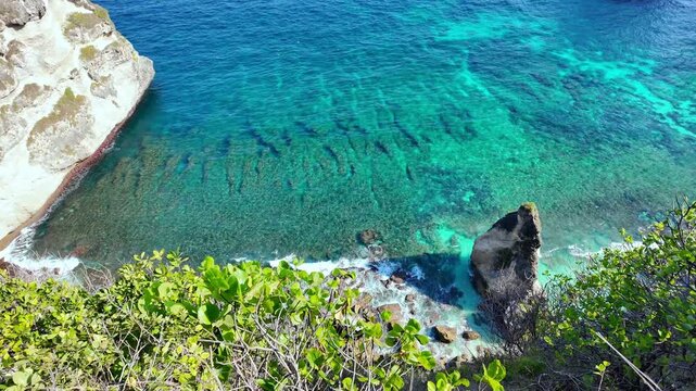panoramic view of Diamond Beach, where azure waves lap against unique rock formations, creating breathtaking visuals of Indonesia coastline