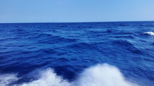 Navigate through turbulent waters, where high waves crash against vessel, producing vibrant splashes and foam, slow motion.