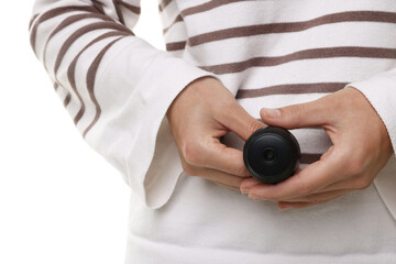 Young woman with hidden spy camera on white background, closeup