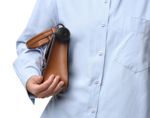 Young woman with hidden spy camera in bag on white background, closeup