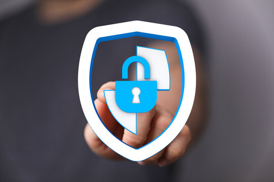 A person pointing at a blue shield icon with a padlock, symbolizing data security and internet privacy. Illustrating protection, safe - Powered by Adobe