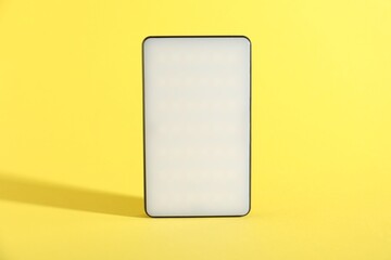 One stylish LED lamp on yellow background