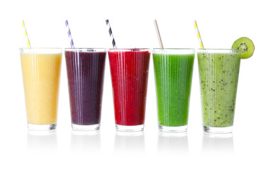 Different tasty smoothies in glasses isolated on white